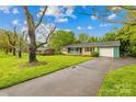 Well-maintained home with beautiful curb appeal, lush lawn, and a paved driveway at 1204 Meadowood Dr, Shelby, NC 28150