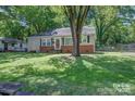 Single-story home featuring a brick foundation and a well-maintained front lawn and mature trees at 1308 Lineberger Ave, Gastonia, NC 28052