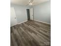 Bright bedroom with light blue walls, wood-look flooring, and a modern ceiling fan at 131 Mays Ct, Rock Hill, SC 29730