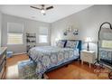 Bright bedroom with hardwood floors, a large bed, and stylish decor at 13610 Aldenbrook Dr, Huntersville, NC 28078