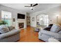 Cozy living room with a fireplace, hardwood floors, and comfortable seating area at 13610 Aldenbrook Dr, Huntersville, NC 28078