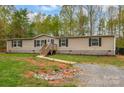 Inviting single-story home features a cozy front porch and meticulous landscaping at 151 Brown Farms Dr, Cleveland, NC 27013