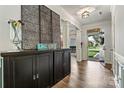 Elegant entryway with dark wood floors, decorative screen, and an open view to the outdoors at 158 Bluffton Rd, Mooresville, NC 28115