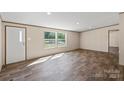 Bright living room featuring wood-look flooring, neutral walls, and ample natural light at 1649 Cloudburst Cir # 6, Lincolnton, NC 28092