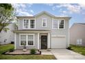 Inviting two-story home with gray siding, a front-facing garage, and a landscaped yard providing excellent curb appeal at 1911 Almond Hills Dr, Charlotte, NC 28262