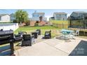 The backyard has a spacious patio area with seating, ideal for enjoying outdoor gatherings at 2207 Atwell Glen Ln, Pineville, NC 28134