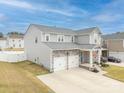 Aerial view of a charming two-story home with well-maintained lawn and a two-car garage at 228 Brownstone Dr, Rock Hill, SC 29730