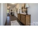 Stylish hallway featuring hardwood floors, a decorative console table, and views into the living room at 228 Mountain Island Dr # 38, Statesville, NC 28677