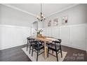 Bright dining room with wainscoting, stylish light fixture, and seating for six at 2311 Lochview St, Pineville, NC 28134