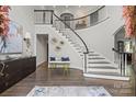 Grand foyer showcases a curved staircase with black railings and hardwood floors at 2500 Giverny Dr, Charlotte, NC 28226