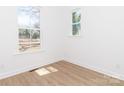 This bedroom offers natural light with two windows and beautiful wood-look vinyl floors at 2501 Elon St, Charlotte, NC 28208