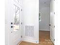 Bright entryway features a door with glass and views to another room with light vinyl flooring at 2501 Elon St, Charlotte, NC 28208