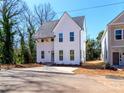 Charming two-story house boasting bright white siding, a dark roof, and a concrete driveway at 2501 Elon St, Charlotte, NC 28208
