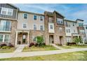 Charming townhome showcasing a combination of stone and neutral siding at 2533 Ensemble Ct, Charlotte, NC 28262