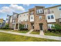 Well-maintained townhomes with stone accents, landscaping, and individual entrances at 2533 Ensemble Ct, Charlotte, NC 28262