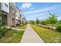 Scenic street view showcasing well-kept townhomes, lush landscaping, and inviting community ambiance at 2533 Ensemble Ct, Charlotte, NC 28262