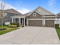 Charming two-story home with three-car garage and well-manicured lawn in a desirable neighborhood at 291 Preston Rd, Mooresville, NC 28117