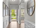Inviting entryway featuring hardwood floors, decorative molding, and an open view to the outdoors at 291 Preston Rd, Mooresville, NC 28117