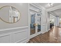 Beautiful hallway leading to a stylish office with glass doors and views of the rest of the home at 291 Preston Rd, Mooresville, NC 28117
