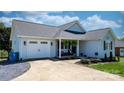 View of the home featuring a two-car garage and a well-maintained lawn with decorative landscaping at 4808 Thoreau Dr, Conover, NC 28613
