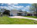 A quaint one-story home featuring a well-manicured lawn, attached garage, and inviting front porch at 4808 Thoreau Dr, Conover, NC 28613