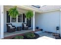 Inviting covered front porch featuring comfortable seating, decorative plants and charming decor elements at 4808 Thoreau Dr, Conover, NC 28613