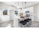 Contemporary kitchen showcasing an island with seating and a view of the backyard at 4827 Victoria Ave, Charlotte, NC 28269
