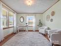Bright living room with hardwood floors, neutral paint, decor, and natural light from large windows at 714 S 8Th St, Bessemer City, NC 28016