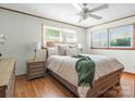 Cozy bedroom with hardwood floors, a ceiling fan, neutral bedding, and ample natural light at 714 S 8Th St, Bessemer City, NC 28016