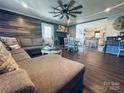 Open-concept living room with fireplace, ceiling fan, and hardwood flooring provides a modern look at 835 Leach Rd, Salisbury, NC 28146