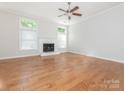 Bright living room featuring hardwood floors, fireplace, neutral paint and large windows for ample natural light at 8718 Rittenhouse Cir, Charlotte, NC 28270