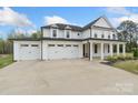 Gorgeous two-story home with a three-car garage, a well-kept lawn, and a welcoming entrance at 8756 Sherrills Ford Rd, Sherrills Ford, NC 28673