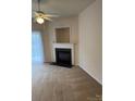 Comfortable living room featuring a fireplace and a ceiling fan at 9668 Walkers Glen Nw Dr, Concord, NC 28027