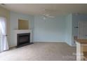 Bright living room featuring a fireplace, carpeted floors and a ceiling fan at 9668 Walkers Glen Nw Dr, Concord, NC 28027