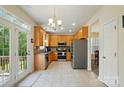 Spacious kitchen featuring stainless steel appliances and access to an outdoor deck at 10056 Paisley Dr, Charlotte, NC 28269