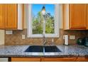 Bright kitchen showcasing a granite countertop and a double basin sink beneath a large window at 10056 Paisley Dr, Charlotte, NC 28269