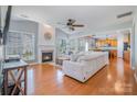 Bright living room with a fireplace, hardwood floors, and large windows that offer plenty of natural light at 10354 Scotland Ave, Fort Mill, SC 29707