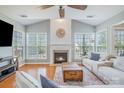 Cozy living room featuring a fireplace, hardwood floors, and a comfortable sofa at 10354 Scotland Ave, Fort Mill, SC 29707