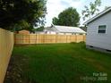 Spacious backyard featuring a brand new wooden fence, providing privacy and a defined property line at 109 W Poplar St, Stanley, NC 28164