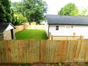 Great home with a spacious backyard featuring a new wooden fence and plenty of room for outdoor activities at 109 W Poplar St, Stanley, NC 28164