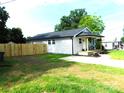 Newly renovated home boasts fresh siding, a new roof, and a charming front porch with green lawn at 109 W Poplar St, Stanley, NC 28164