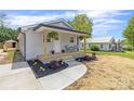 Inviting single-story home features a cozy front porch, neat landscaping, and a smooth walkway leading to the entrance at 109 W Poplar St, Stanley, NC 28164