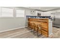 Open-concept living space with hardwood floors, natural light, and seamless connections to the kitchen at 109 W Poplar St, Stanley, NC 28164
