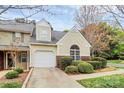 Inviting townhome with attached garage, complemented by lush greenery and a cozy appeal at 11539 Delores Ferguson Ln, Charlotte, NC 28277