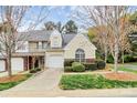 Well-maintained townhome featuring an attached garage, lush lawn and easy access to main street at 11539 Delores Ferguson Ln, Charlotte, NC 28277
