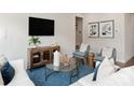 Bright living room features hardwood floors, stylish furniture, and a chic coffee table with tasteful decor at 117 Vaquaro Dr, Mooresville, NC 28115