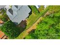 Aerial view showcasing the home's roof, backyard, and surrounding lush greenery at 12531 Morning Creek Ln, Charlotte, NC 28214