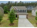 Charming two-story home with a brick facade, a two-car garage, and well-maintained landscaping at 127 Slip Shot Ln, Troutman, NC 28166