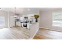Bright kitchen with stainless steel appliances, granite countertops, white cabinets and modern lighting at 1274 Oakbrook Ln, Denver, NC 28037