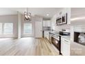 Bright kitchen features stainless steel appliances, granite countertops, and light colored wood flooring at 1274 Oakbrook Ln, Denver, NC 28037